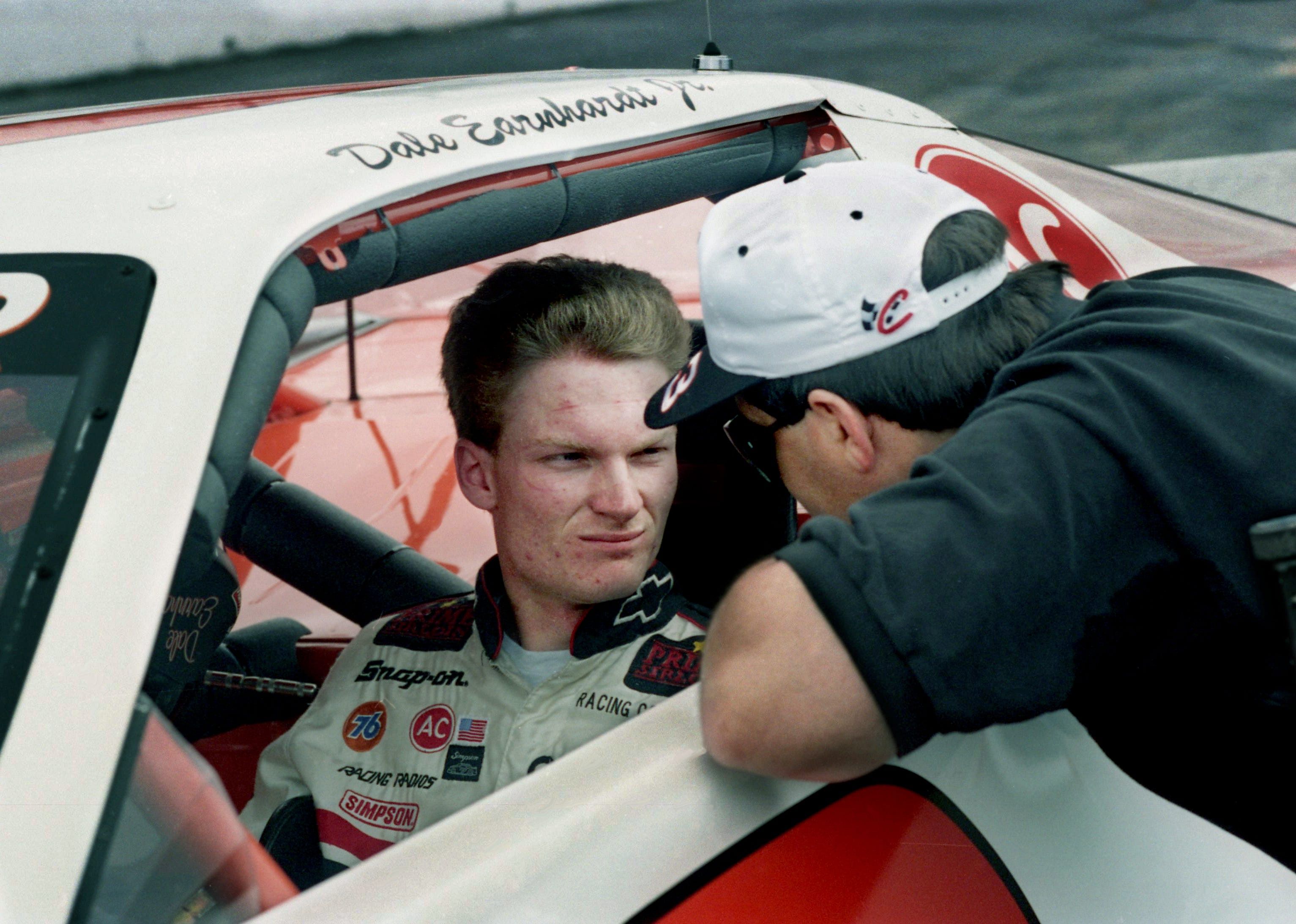 The 22-year-old race driving son of NASCAR superstar Dale Earnhardt Sr., talks strategy with Jeff Green as he checks out the Nashville Speedway April 19, 1996. - Source: Imagn